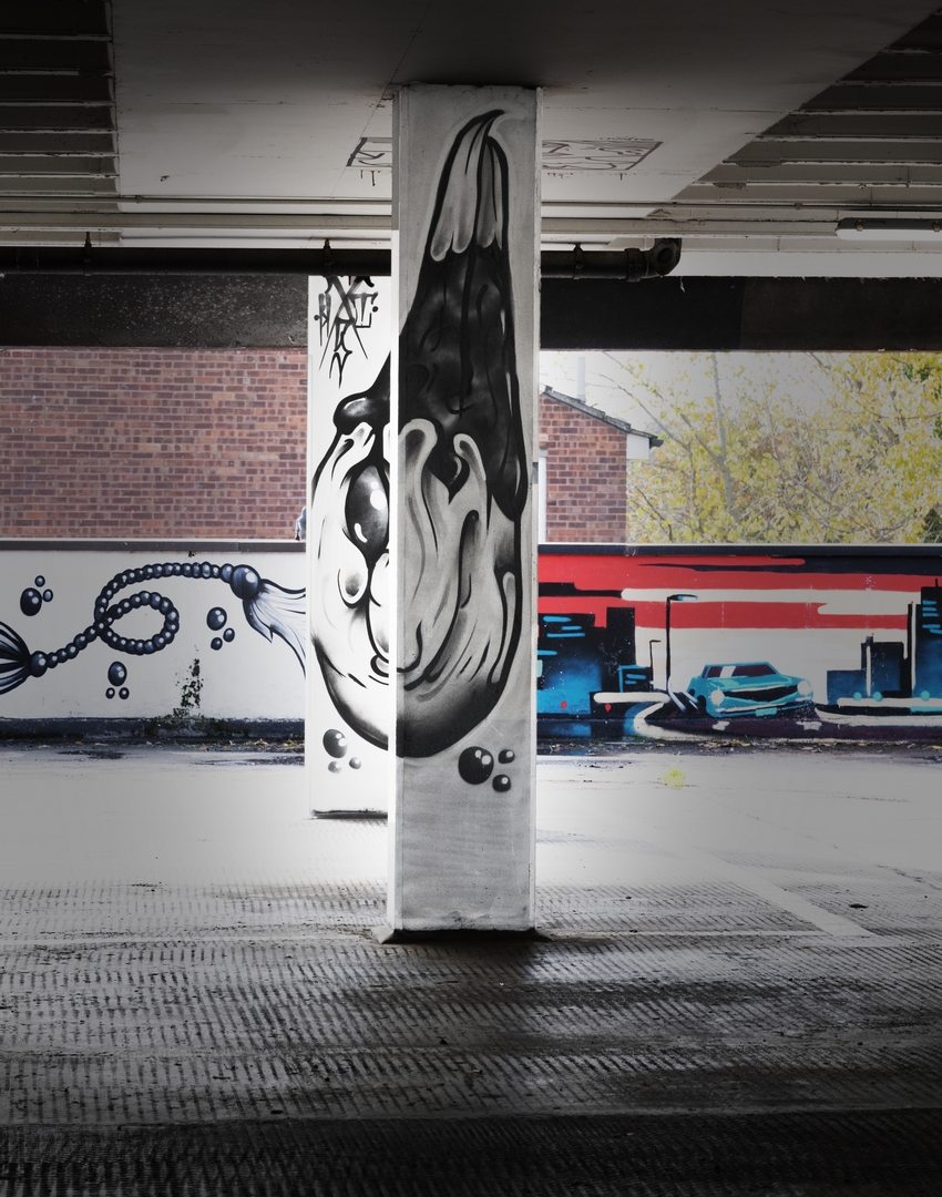 A composite mural of a bird head split over two pillars in Penge