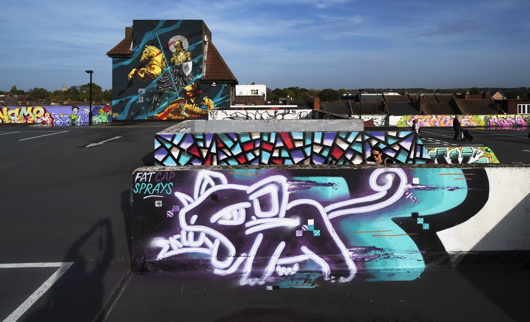 staggered walls with layers of street art and graffiti in Penge with a huge Reves and Sidok collaboration