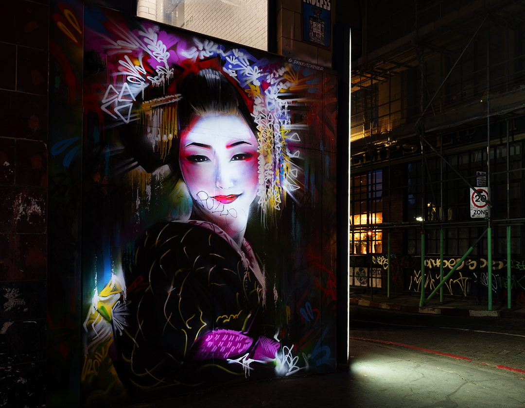painted geisha girl mural at night in shoreditch by Dan Kitchener